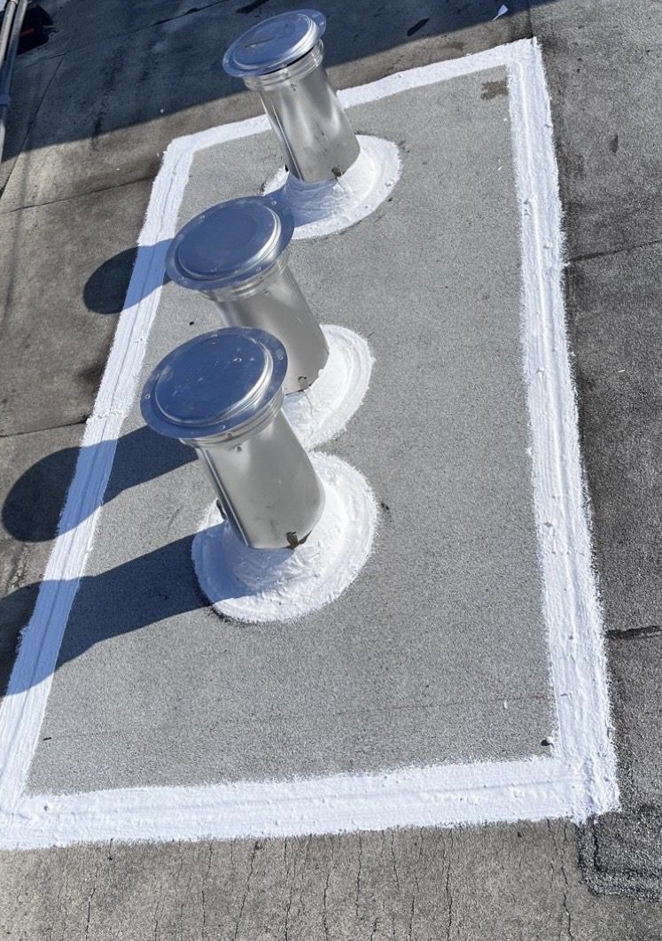 Three metal roof vents on sealed patch