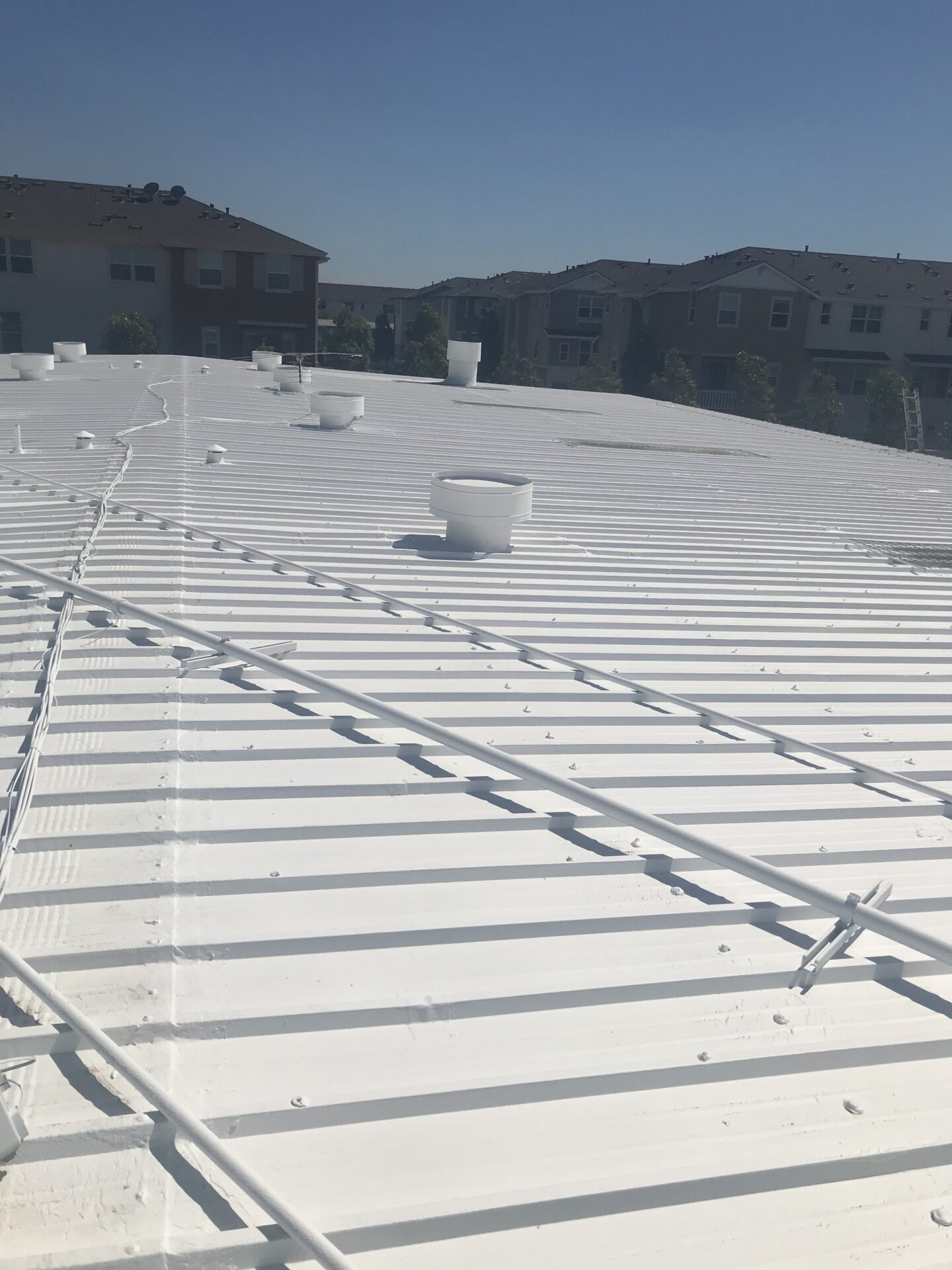 White corrugated roof with vents and rails
