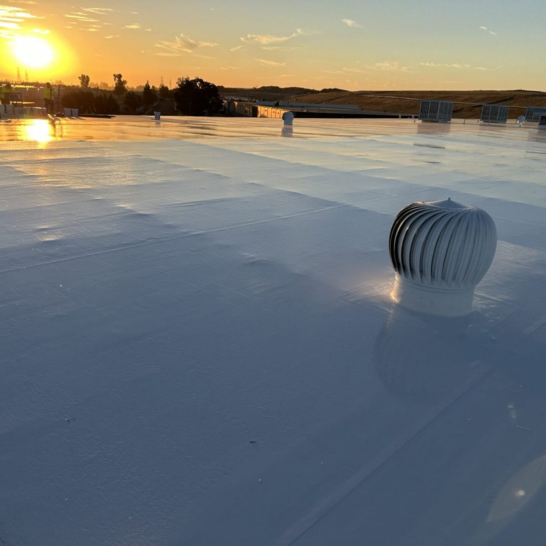 White flat commercial roof with turbine vent